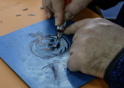 Image shows delegate cutting the lino on the Lino Printing workshop from Photoartcollections